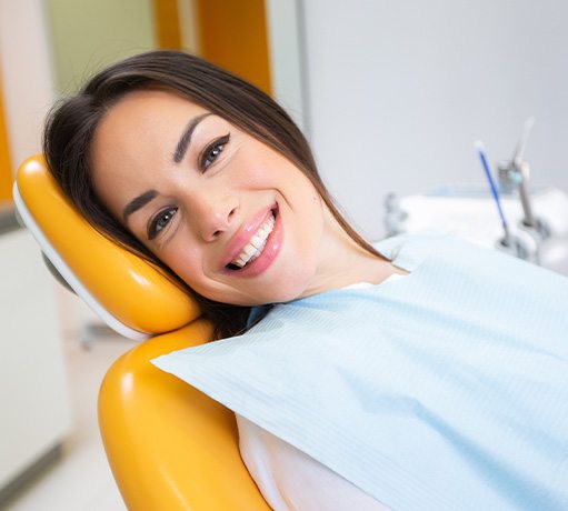 Woman smiling while relaxing in treatment chair