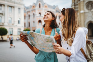 Two women abroad looking at a map for directions